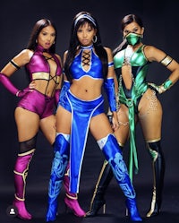 three women in kung fu costumes posing for a photo